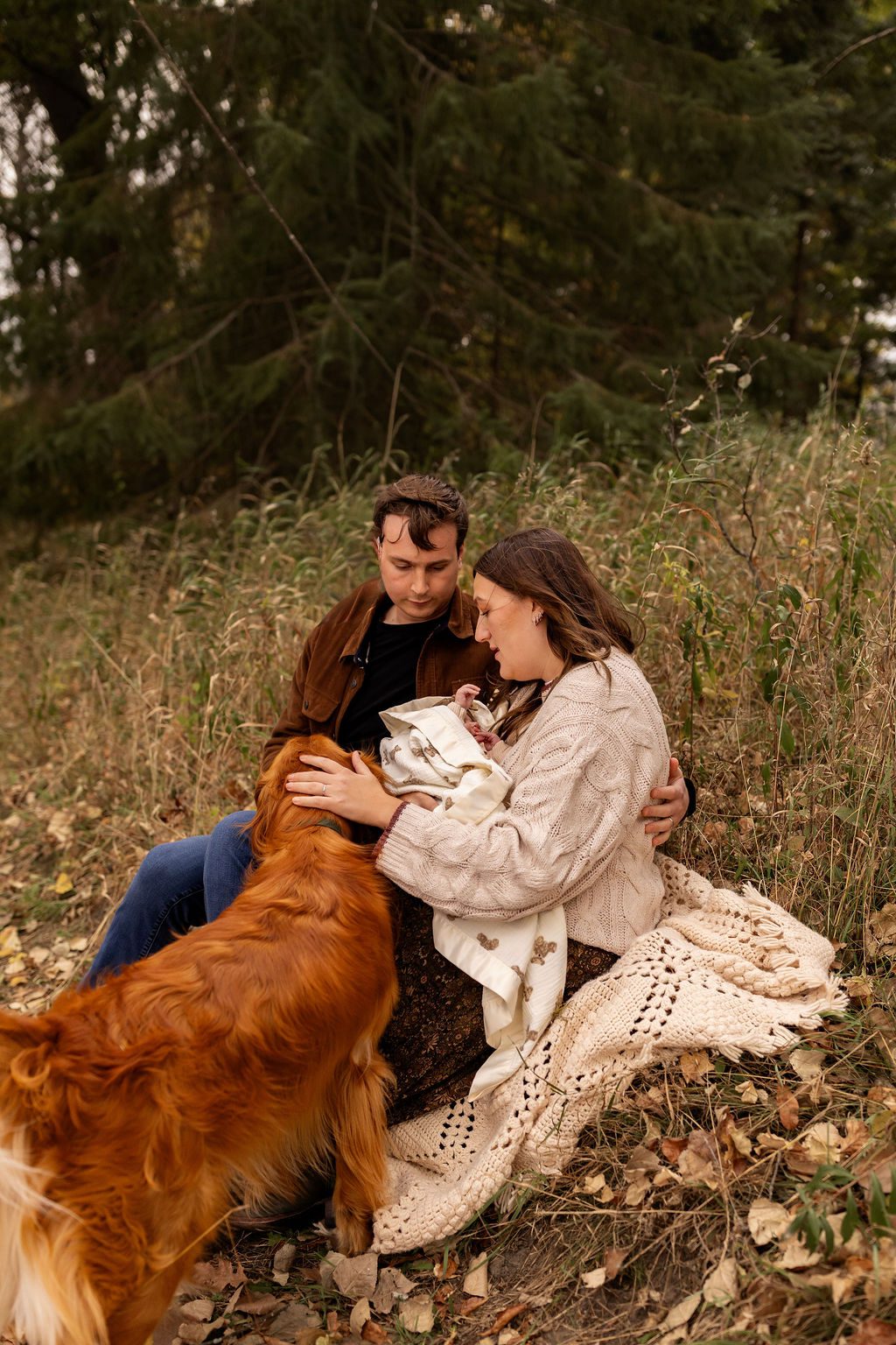 family with a newborn and a dog being photographed outdoors in the fall in Forest Lake, Minnesota