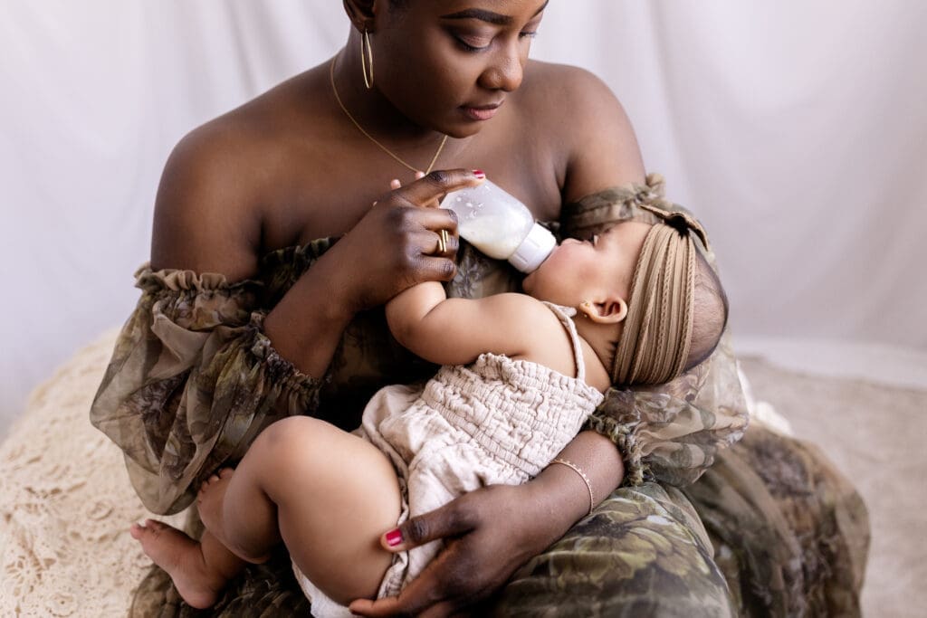 Mom feeds 6 month old during a motherhood session at a studio iwht a Lindstrom photographer